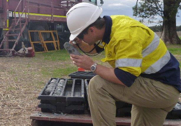 Worker examining drill cores