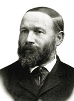Black and white photo of George Ulrich in a suit and beard