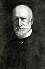 Black and white photo of Alfred Howitt wearing a suit and neat white beard