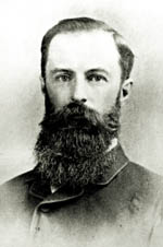Black and white photo of Reginald Murray wearing a suit and a long, dark beard