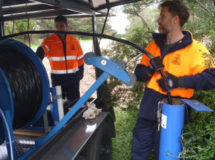 Workers collecting water samples.