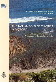 Two men walking along a rock ridge in a forest setting