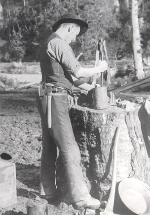 Crushing quartz in a dolly pot near Ballarat in the 1880s. The miner pounds quartz with a mortar and then empties the residue into a dish and pans. This method was used to test for gold before working an area. An old black and white photo of a miner crushing quartz in a pot.