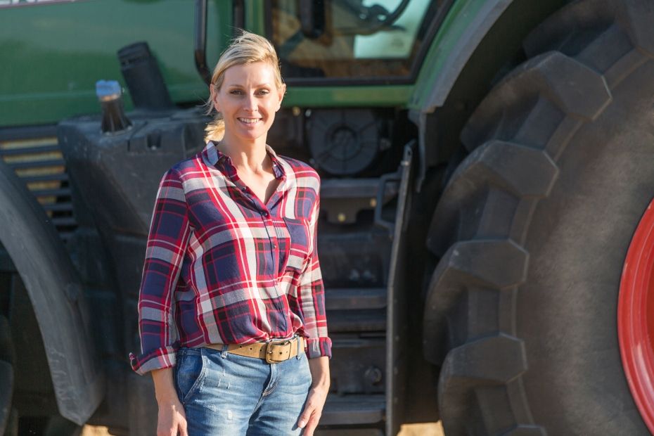 woman standing in front of tractor