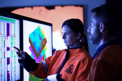 Staff reviewing data on computer screen.